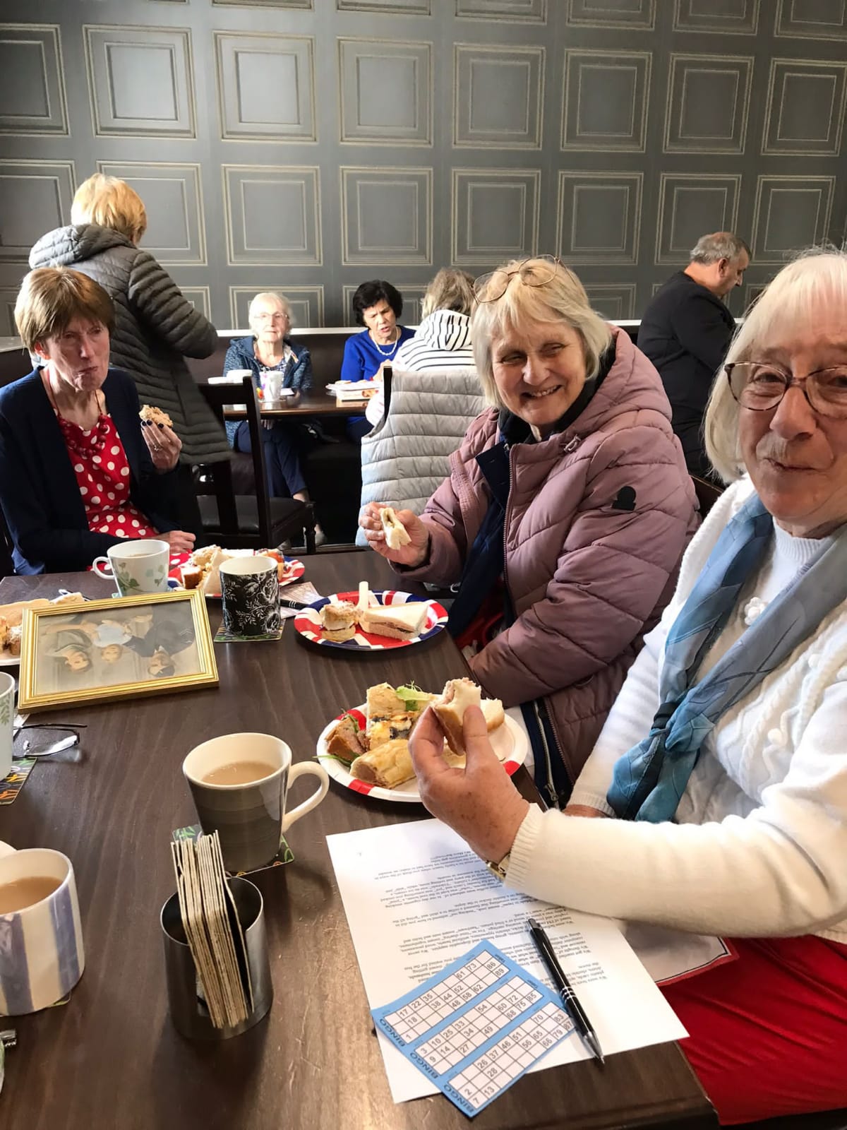 Members enjoying a bingo game during a club meeting